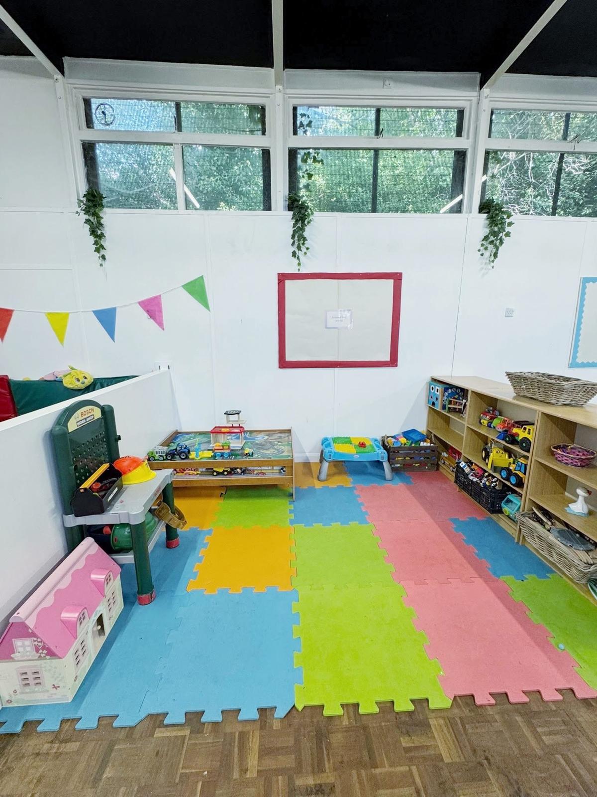 Rochester play space with colourful mats and role-play toys